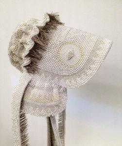 A wedding bonnet made of straight pins